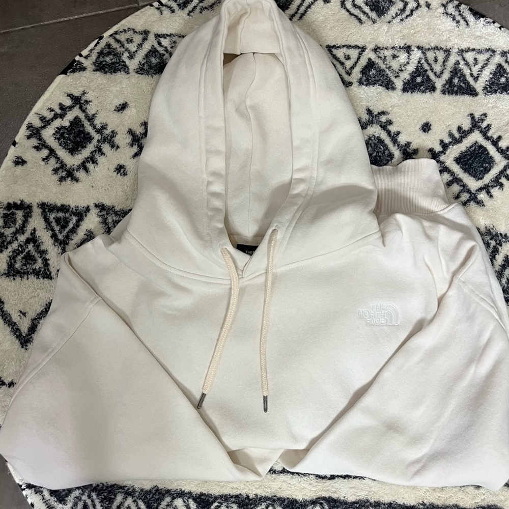 The North Face cream hooded sweatshirt. Size Medium.